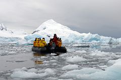 07A Zodiac In Loose Ice In Paradise Harbour With Mount Banck On Quark Expeditions Antarctica Cruise.jpg